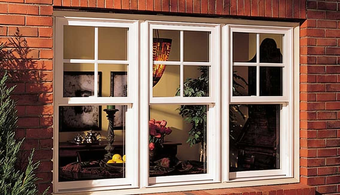 Brick exterior home featuring three white-framed Double Hung Windows Atlanta with classic grid design, showcasing smooth vertical sash operation, traditional architecture, and elegant residential window styling.