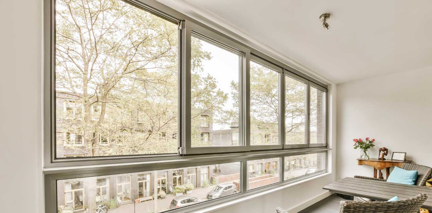 Bright modern living space featuring large horizontal Sliding Windows Atlanta with sleek frames, expansive outdoor views, abundant natural light, and contemporary interior design.