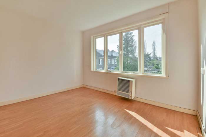 Empty residential room with large multi-pane window allowing natural light, highlighting professional Window Replacement Gadsden, AL for home interior upgrades